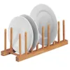 A bamboo plate rack holding three white plates. Produktbild-Vorschau