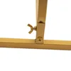 A close-up view of a gold metal stand's joint and fastening mechanism. Produktbild-Vorschau