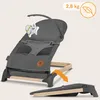 A baby bouncer chair is shown in a studio setting, with an arrow indicating it can be folded. Produktbild-Vorschau