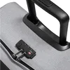 A close-up of a gray suitcase with a black combination lock and a black handle. Produktbild-Vorschau
