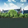 A dark green privacy screen in the foreground, with a building and trees in the background under a blue sky with clouds. Podgląd zdjęcia produktu