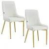 Two cream-colored velvet dining chairs with gold metal legs are shown against a white background. Náhľad obrázku produktu