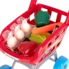 A close-up shot of a toy shopping cart filled with plastic toy food items. Náhled obrázku produktu