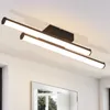A modern black LED ceiling light with two linear light bars is mounted on a white ceiling. Podgląd zdjęcia produktu