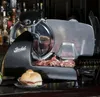 A Berkel slicer with a sandwich in the foreground. Produktbild-Vorschau