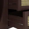 Close-up view of drawers and cane detailing on a wooden sideboard. Produktbild-Vorschau