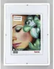 A framed picture of a woman's face with orchids. Anteprima dell’immagine prodotto