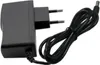 A black power adapter with a coiled cord and a European plug. Produktbild-Vorschau
