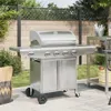 A stainless steel gas grill is shown on a patio with a fence and greenery in the background. Produktbild-Vorschau