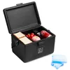 A black cooler box with its lid open, showing food and a drink inside, along with two ice packs next to it. Produktbild-Vorschau