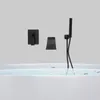 A black bathtub faucet and showerhead are mounted on a light gray wall above a white bathtub filled with water and flower petals. Podgląd zdjęcia produktu