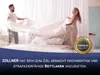A couple is making a bed with a white sheet. Produktbild-Vorschau
