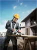 A construction worker is using a circular saw to cut a piece of wood on a construction site. Anteprima dell’immagine prodotto