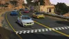 A group of cars racing on a road with a checkered finish line. Produktbild-Vorschau