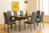 A dining room setting with a table and chairs. Produktbild-Vorschau