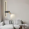 A modern living room with a sectional sofa and a wall lamp. Produktbild-Vorschau
