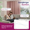 A couple relaxing on a couch in a living room, with a window showing a rainy street scene. Produktbild-Vorschau