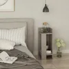 A bedside table next to a bed with pillows and a book. Podgląd zdjęcia produktu
