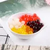 A white bowl filled with colorful popping boba pearls. Produktbild-Vorschau