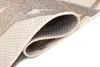 A close-up view of a rolled-up rug, showing the texture and pattern of the material. Náhled obrázku produktu
