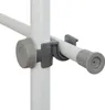 A close-up view of a white and gray adjustable clamp mechanism on a white pole, likely part of a wardrobe or shelving system. Produktbild-Vorschau