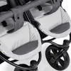 A close-up view of the seats and wheels of a double stroller. Produktbild-Vorschau