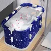 A portable bathtub filled with water and rose petals, with a tray holding a wine glass and other items. Produktbild-Vorschau
