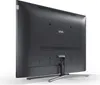 The back of a black television set on a stand, against a white background. Produktbild-Vorschau