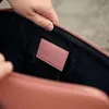 A close-up shot of the inside of a pink bag, showing a pink label with the GOLLA logo. Voir les images du produit