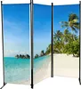 A three-panel room divider displaying a tropical beach scene with overwater bungalows and palm trees. Produktbild-Vorschau