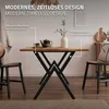 A dining table with a wooden top and black metal legs, set in a modern dining room with chairs and decorative items. Produktbild-Vorschau