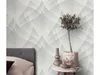 A bedroom scene with wallpaper, a bed, and decorative items on a table. Produktbild-Vorschau