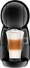 A black Dolce Gusto coffee machine with a glass of latte macchiato in front of it. Podgląd zdjęcia produktu