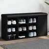 A black shoe bench with multiple compartments and a closed cabinet on the right, filled with various shoes. Podgląd zdjęcia produktu