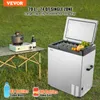 An outdoor scene with a portable refrigerator, a camping stove, and drinks on a table. Produktbild-Vorschau