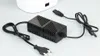 A white dehumidifier unit is partially visible in the background, with a black power adapter and two black cables in the foreground. Náhled obrázku produktu