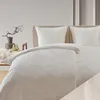 A neatly made bed with white bedding and pillows. Voir les images du produit