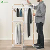 A man is standing next to a multi-tiered drying rack with clothes on it. Produktbild-Vorschau