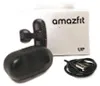 A black Amazfit UP wireless earbud set with its charging cable and packaging. Voir les images du produit