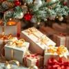 Christmas gifts wrapped with gold and red ribbons under a decorated Christmas tree. Produktbild-Vorschau