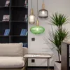 A living room scene with a sofa, bookshelf, plant, and pendant lights. Anteprima dell’immagine prodotto