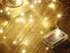 A close-up of a string of warm white LED lights with a battery pack on a wooden surface. Náhled obrázku produktu