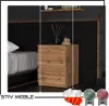 A modern bedroom setting with a nightstand next to a bed. Produktbild-Vorschau