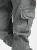 A close-up view of the cargo pocket and leg of a pair of gray cargo pants. Produktbild-Vorschau