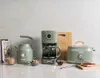 A collection of kitchen appliances including a toaster, coffee maker, and kettle, along with some breakfast items like sugar cubes and toast. Náhled obrázku produktu