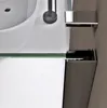A close-up view of a modern bathroom sink and shower enclosure. Produktbild-Vorschau