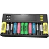 A battery charger with multiple batteries inserted, displayed against a black background. Voir les images du produit