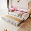 A modern bedroom with a white upholstered daybed featuring integrated LED lighting and storage compartments in the headboard. A trundle bed is pulled out from underneath. Náhled obrázku produktu