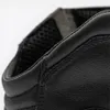 A close-up view of the top edge of a black leather shoe. Podgląd zdjęcia produktu