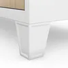 A close-up view of the bottom corner of a white cabinet, showing one of its white, tapered legs. Voir les images du produit